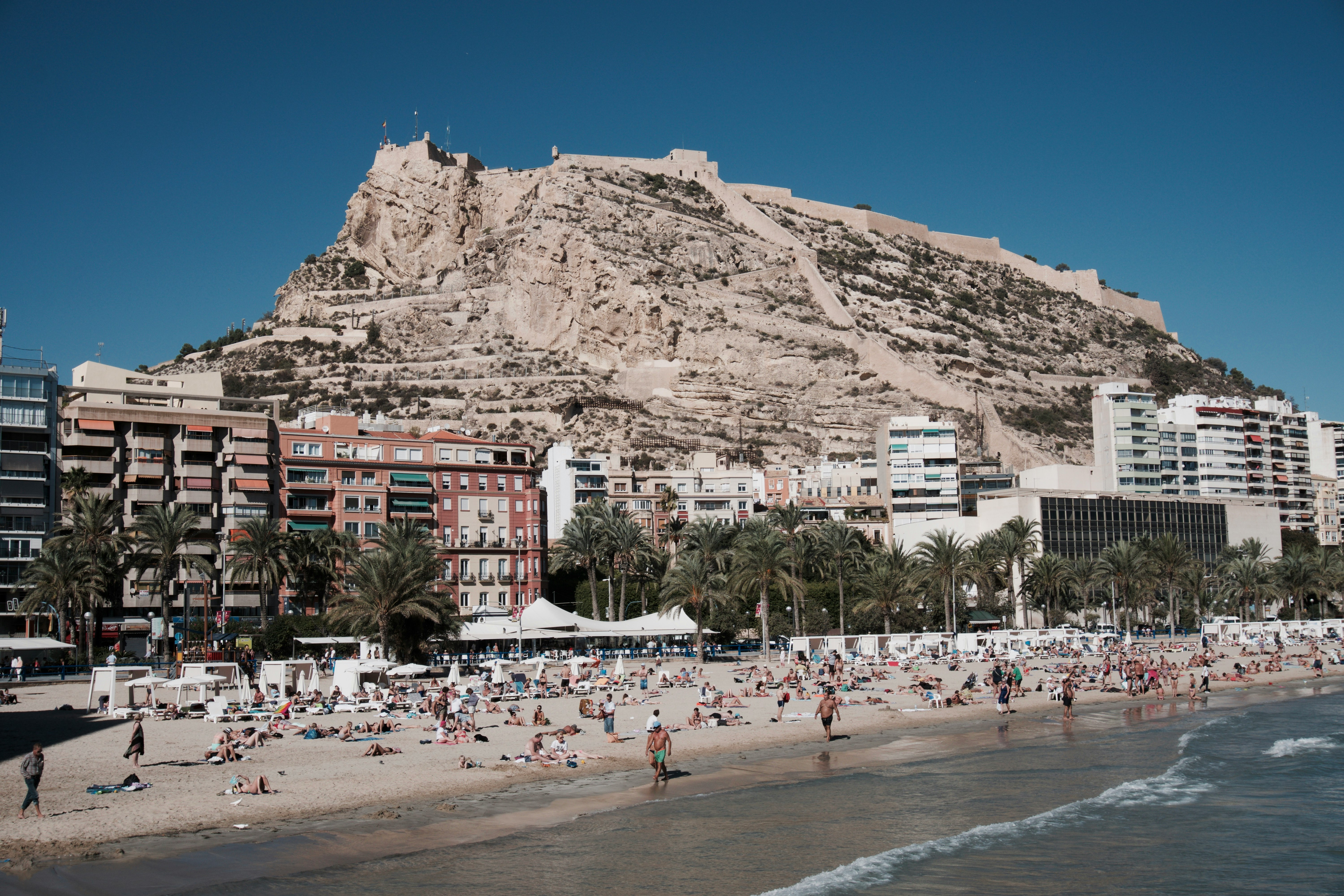 seashore near buildings under clear blue sky during daytime